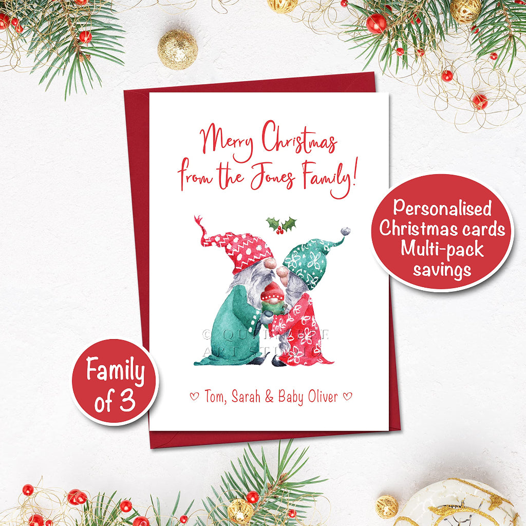 A personalised Christmas card featuring an illustration of two gnomes and a baby, with a red envelope. The card is titled 'Merry Christmas from the Jones Family' and includes personalisations of names
