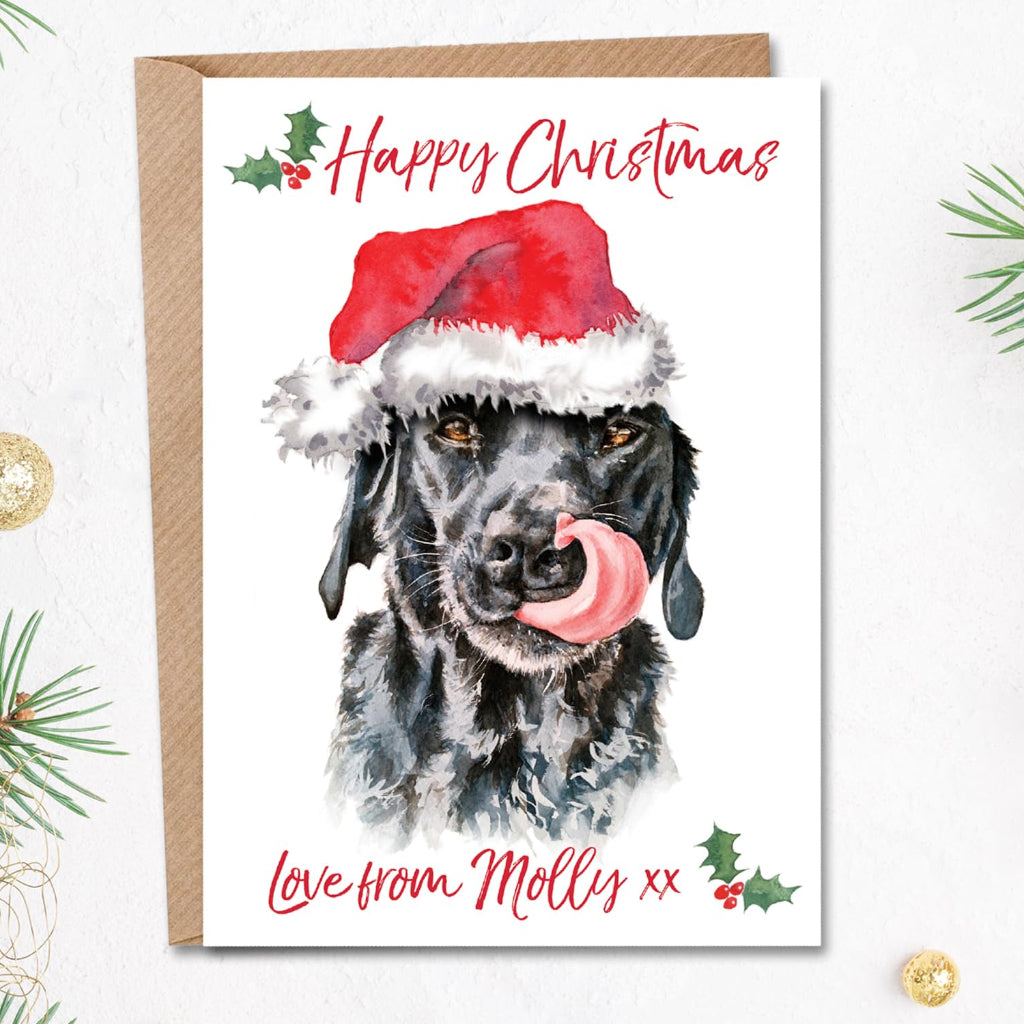 Personalised black labrador Christmas card from the dog. The front features a cute painting of a black lab licking her nose in a santa hat.