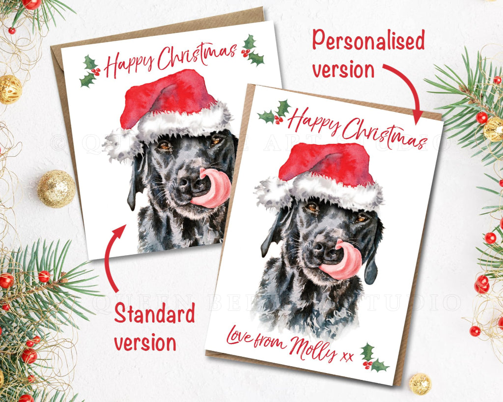 2 Happy Christmas cards with funny picture of black labrador licking its nose wearing a santa hat. One is personalised with dog's name, the other is the standard version