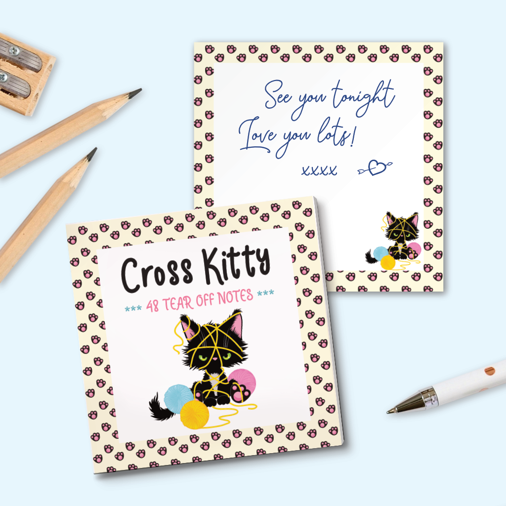 A small notepad with an illustration of black kitten tangled in wool, with a pastel yellow border with paw prints. An example page is shown with a small cat illustration, with a short message written on it