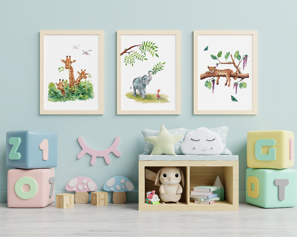 set of 3 cute jungle animal pictures hanging on playroom wall, with giraffes, elephant and leopard