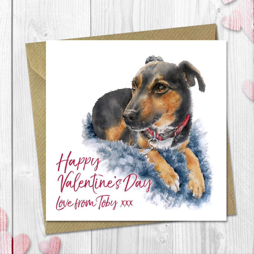 Personalised Valentine's Day card with a dog illustration of a black and tan jack russell terrier and 'Happy Valentine's Day' text on a wooden surface with heart decorations.