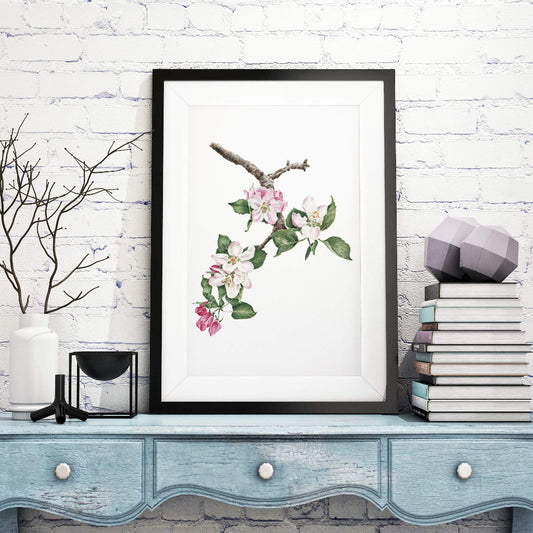 room setting with large apple blossom picture in black frame on mantel