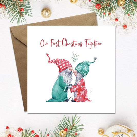 Christmas card with two gnomes holding hands and 'Our First Christmas Together' text, surrounded by festive decorations.