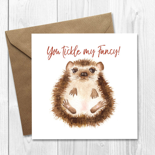 Greeting card with cute hedgehog illustration and text 'You Tickle my Fancy!' on a white background, for valentine's day, anniversary or birthday.