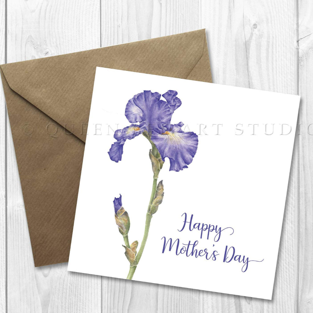 A floral Mother's Day card featuring a blue iris with the text 'Happy Mother's Day' on it, accompanied by a brown craft envelope.
