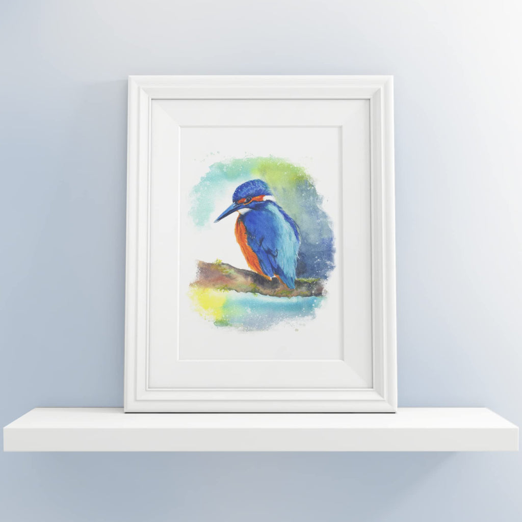 small framed picture of kingfisher on shelf in pale grey blue room