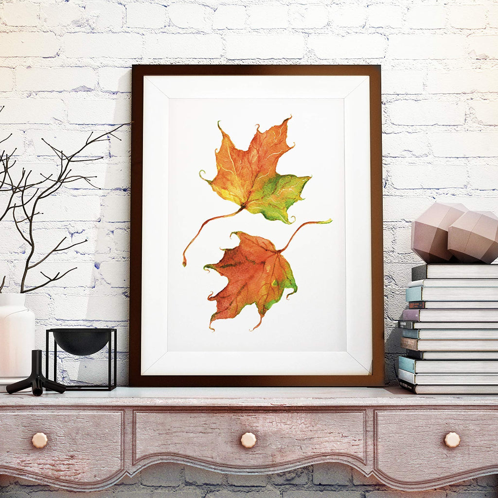 large framed picture of 2 autumn colour maple leaves in rustic farmhouse country room setting