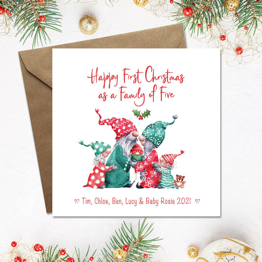 A personalized Christmas card with illustration of a family of five cute gnomes, with a Christmas theme, in red and green colors. The card has 'Happy First Christmas as a Family of Five' text and a space for personalization with names.