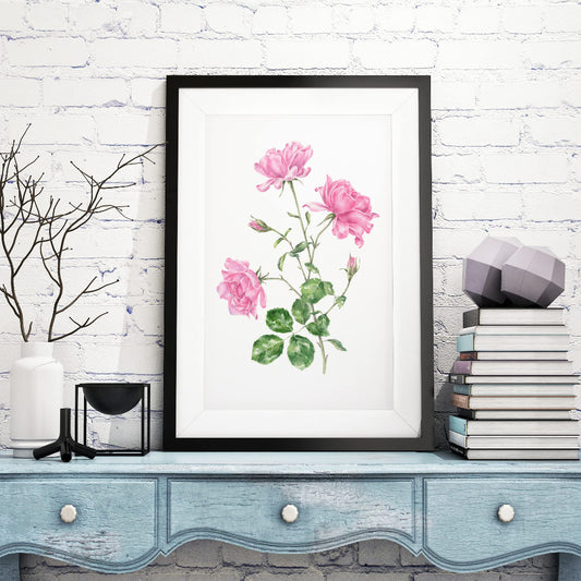 Large framed watercolour art print with bright pink roses in cottagecore rustic room setting