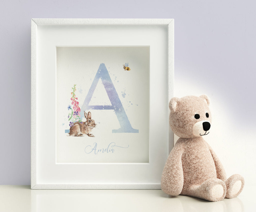 sweet framed picture of personalised flower and rabbit print, with large initial or monogram in shaded of blue and lilac