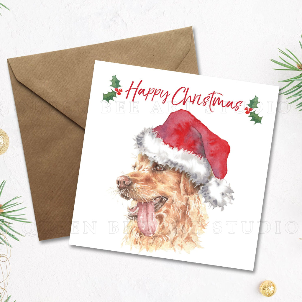 Square Happy Christmas card with a cute golden retriever in a santa hat on the front, with a kraft envelope