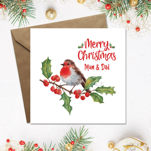 Christmas card with a robin and holly design, featuring 'Merry Christmas Mum & Dad' text, on a white background with festive decorations.