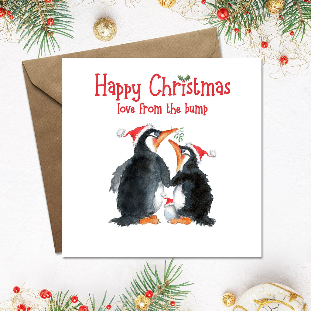 Square christmas card from the bump with cute penguin couple and egg in a santa hat