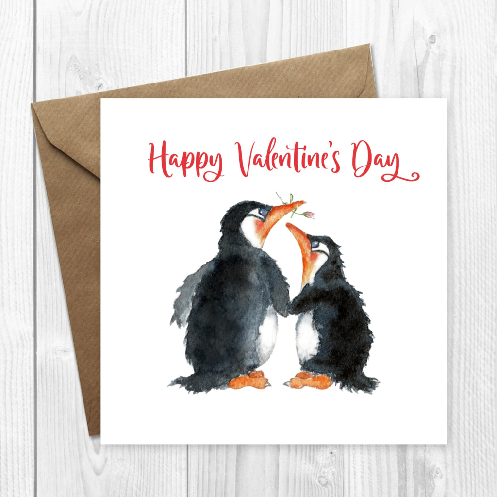 A cute Happy Valentine's Day card with an illustration of 2 penguins holding hands