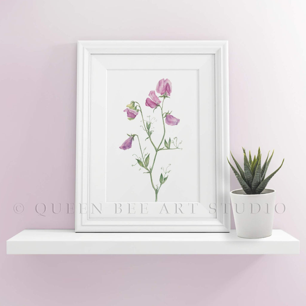 pink sweet pea art print in white frame on shelf