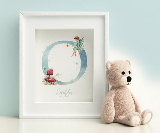 Framed picture of a large letter monogram print with a fairy and red mushrooms, personalised with a girl's name